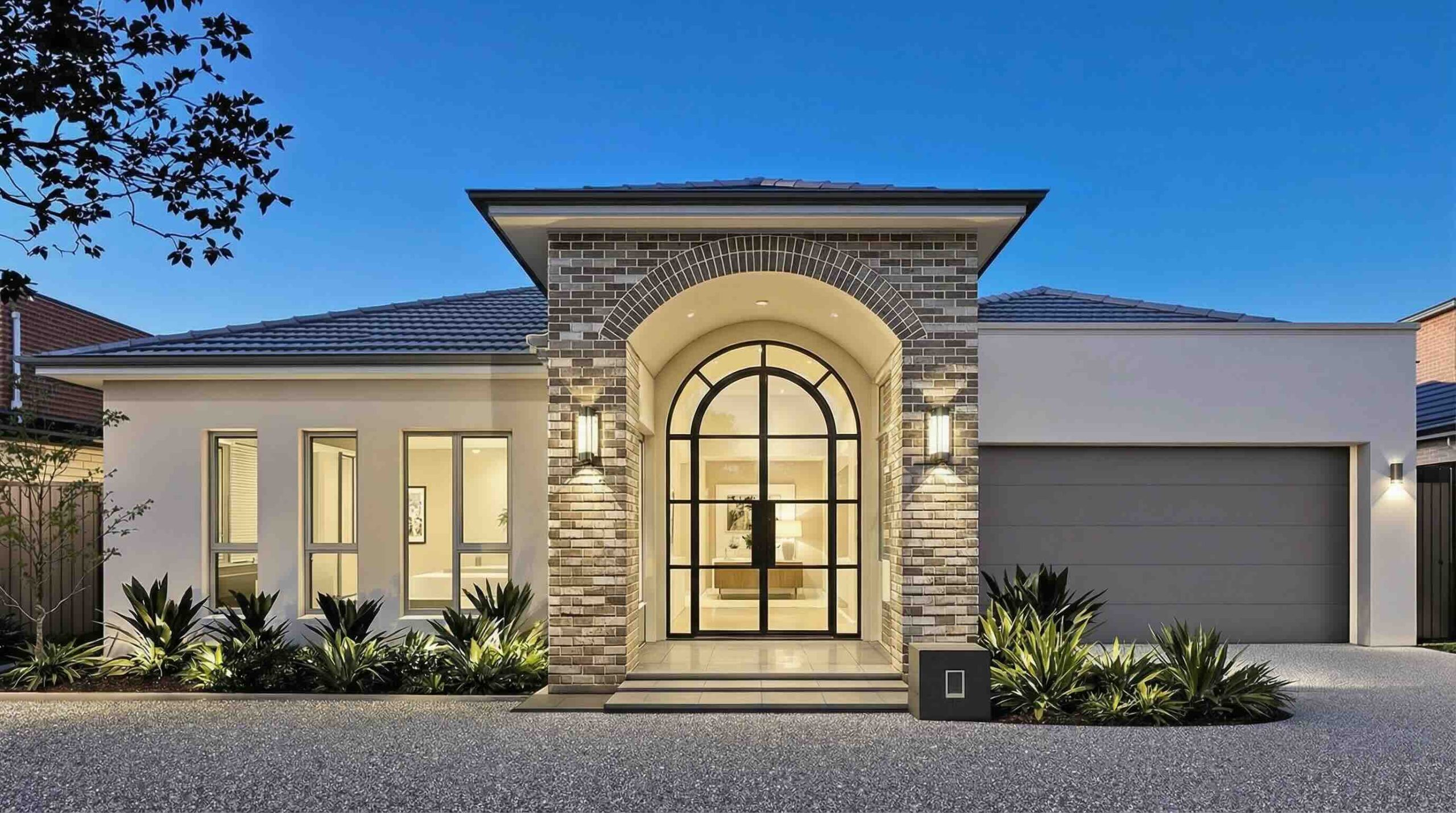 Double glazed arched doors Perth home entrance with feature stone cladding at twilight